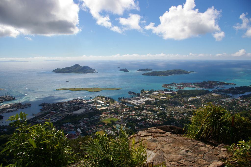 Stunning aerial landscape of Seychelles islands and ocean from a mountain viewpoint under a bright sky.